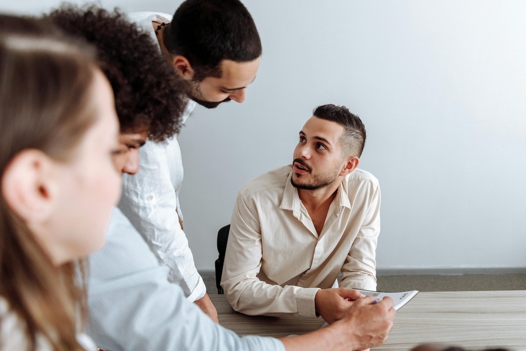  group of colleagues collaborating on a project, symbolizing teamwork in implementing Green IT strategies and sustainable software development practices within a business environment.