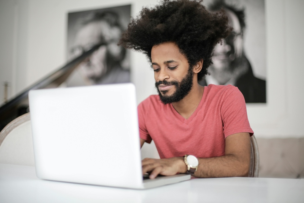 A software developer working on a laptop, representing individual contributions to Green IT and green software development through sustainable coding practices.