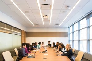 Discussion between multiple colleagues in a conference room.