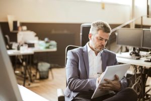 An employee looking through the business benefits of ISO standards.