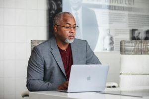 A man reading about the EU AI Act on his laptop in an office.